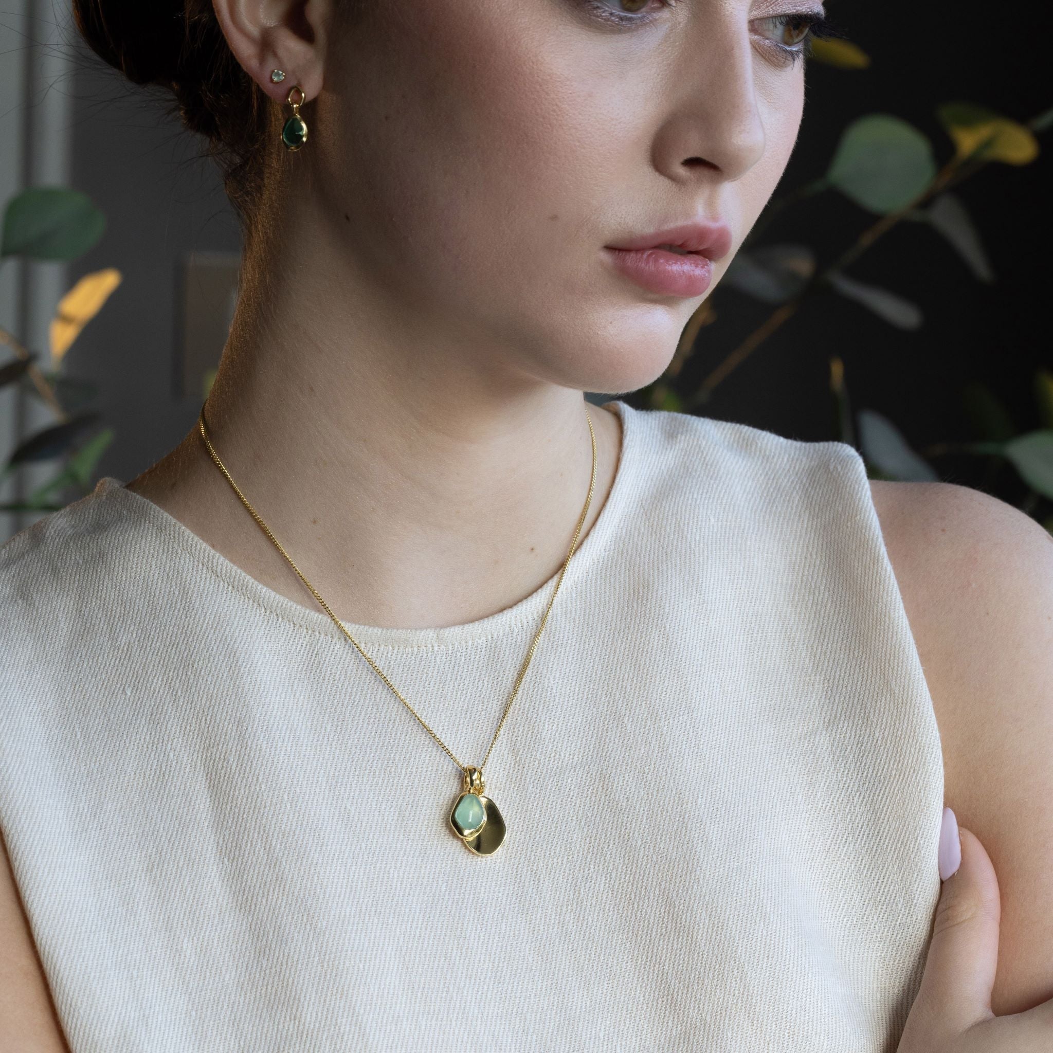 Pebble Charms necklace features a smooth, polished Pebble charm, nestled alongside a sparkling handcut Gemstone charm.