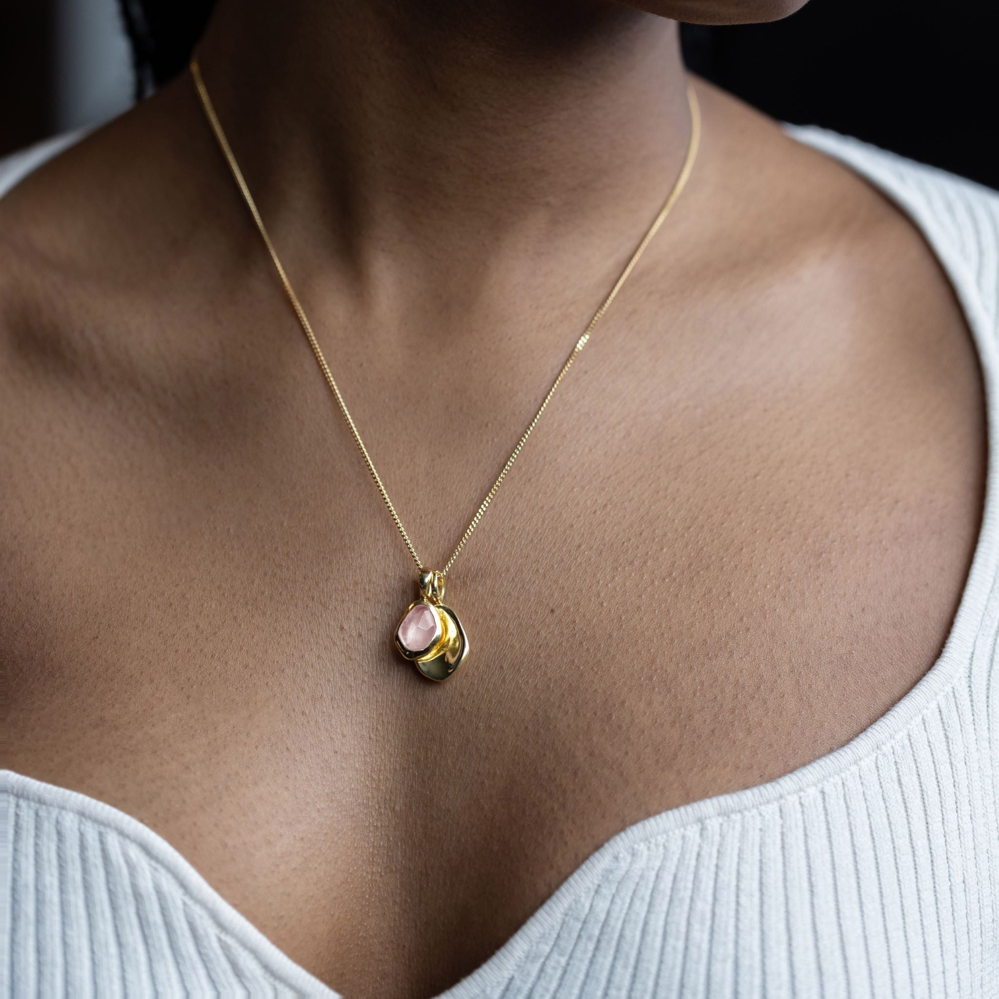 Pebble Charms necklace features a smooth, polished Pebble charm, nestled alongside a sparkling handcut Gemstone charm.