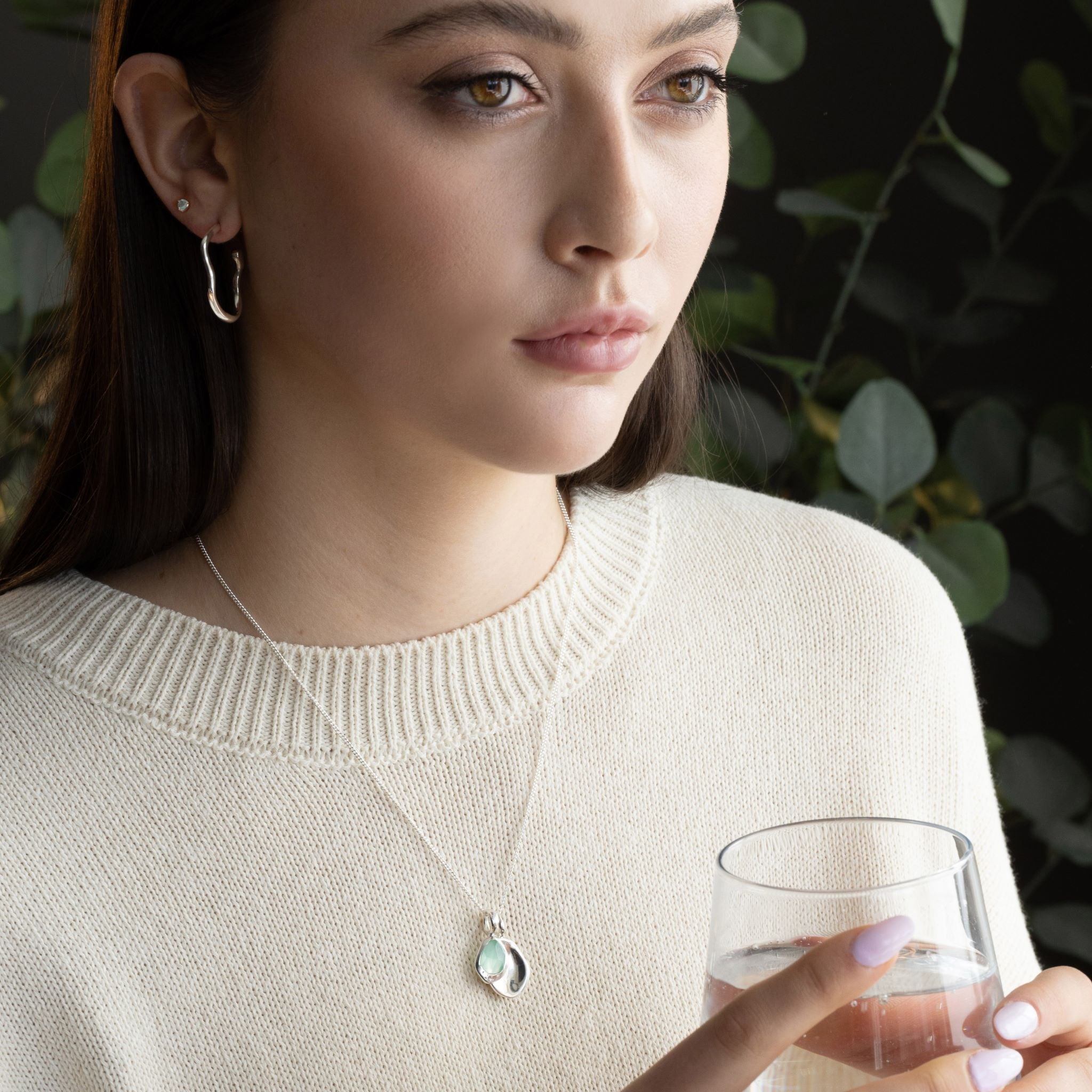 Pebble Charms necklace features a smooth, polished Pebble charm, nestled alongside a sparkling handcut Gemstone charm.