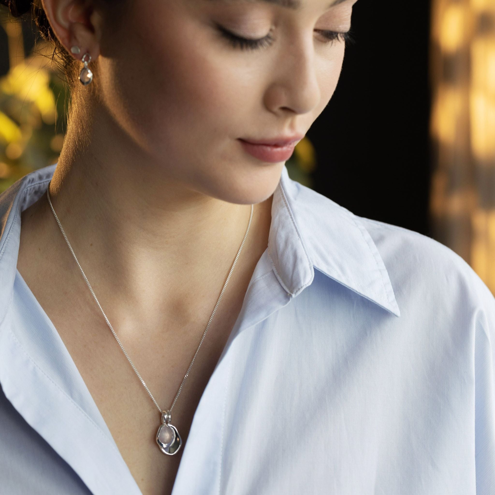 Pebble Charms necklace features a smooth, polished Pebble charm, nestled alongside a sparkling handcut Gemstone charm.