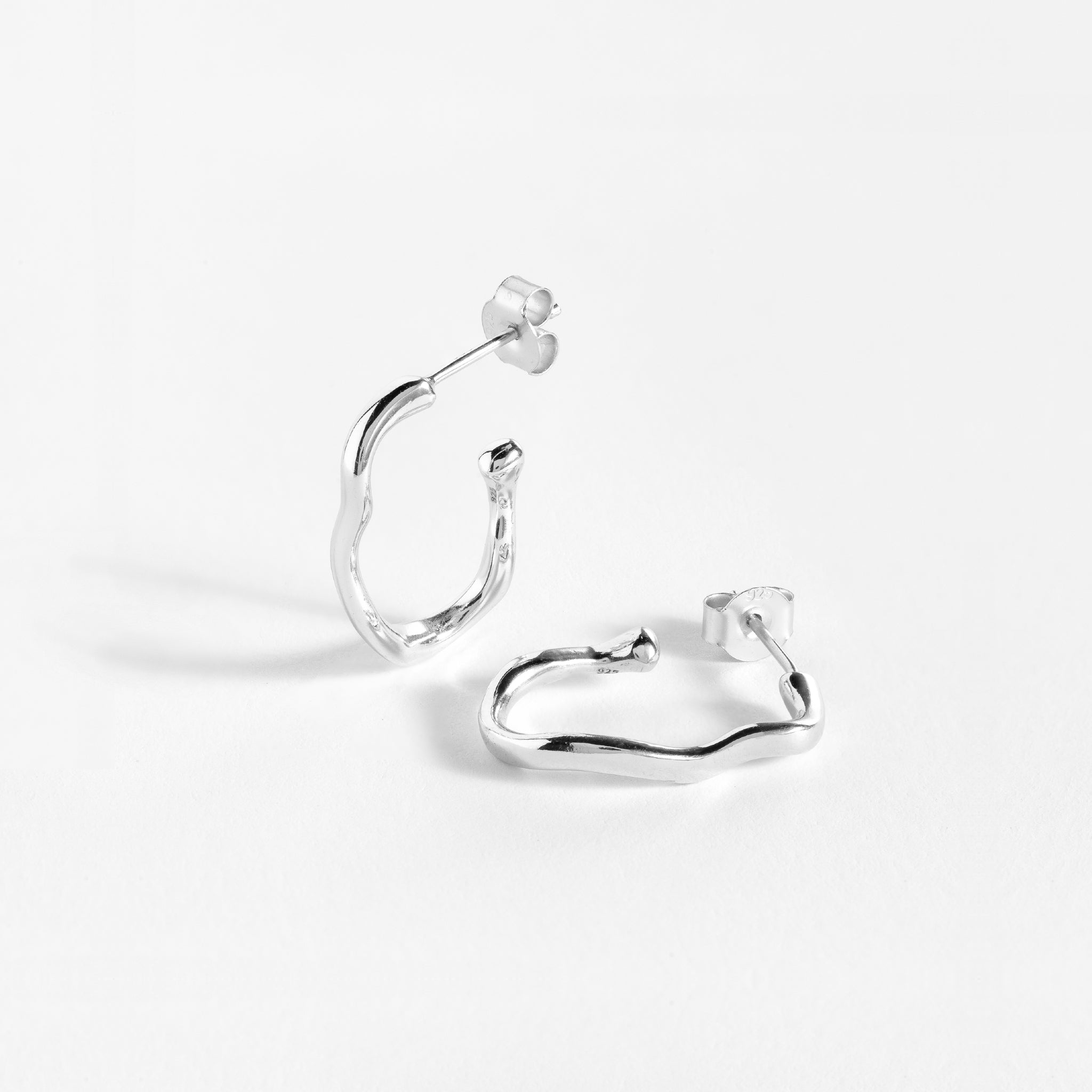 Earring features a handcut natural ripple shape and is crafted from sterling silver or 18ct gold vermeil.
