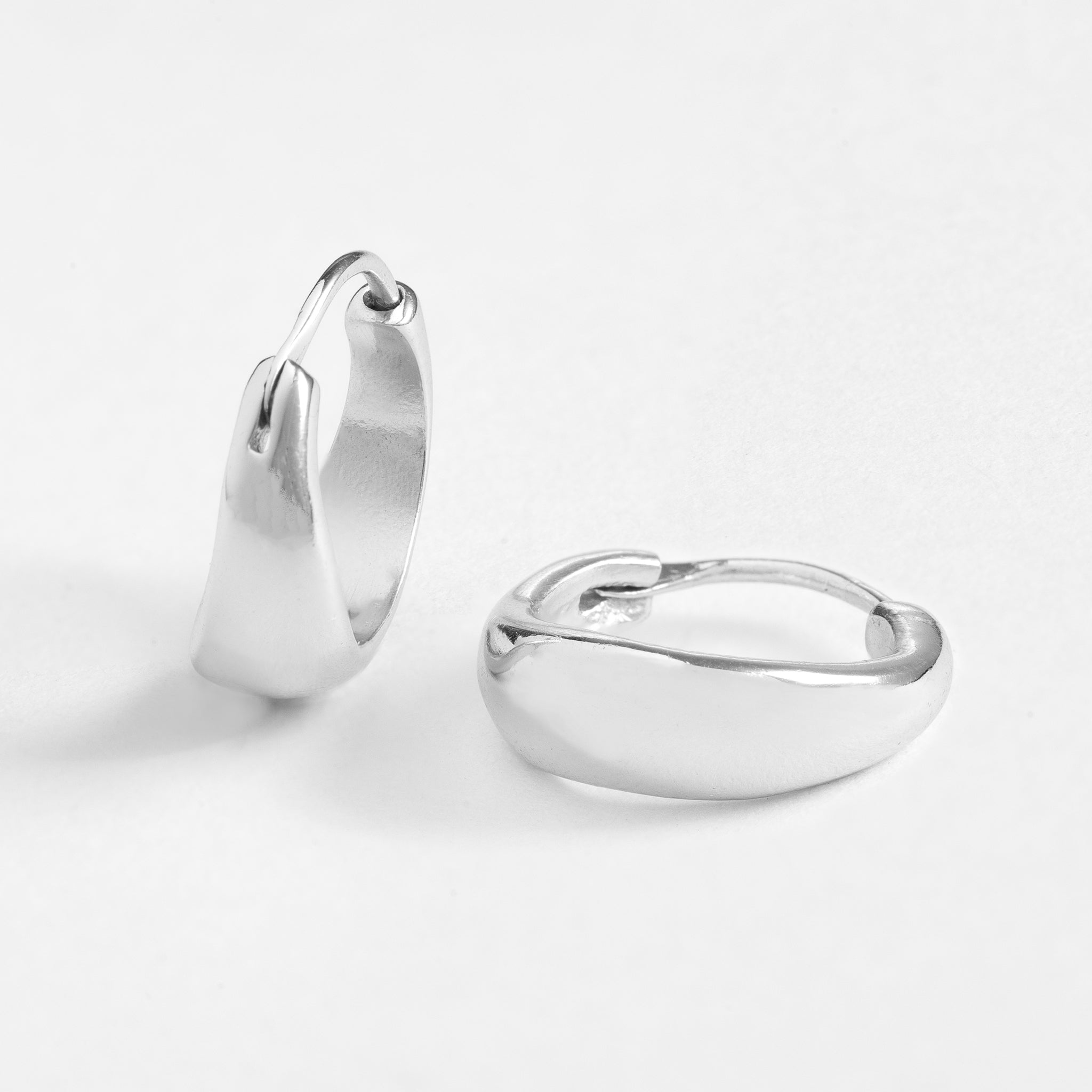 Huggie features a handcut natural round shape and is crafted from sterling silver or 18ct gold vermeil.