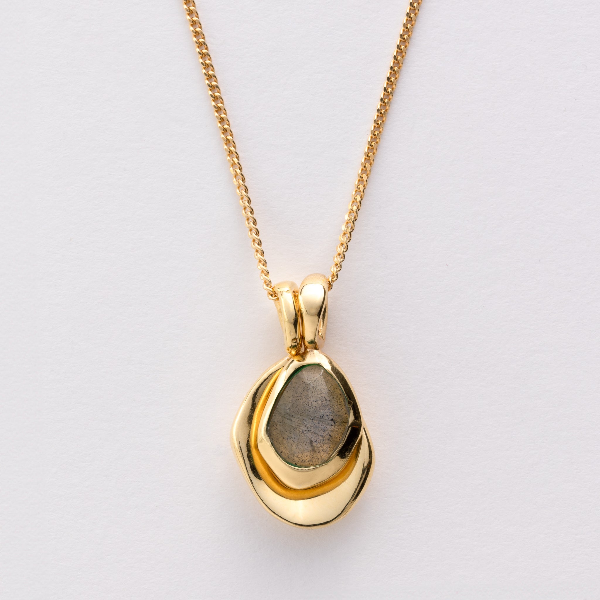 Pebble Charms necklace features a smooth, polished Pebble charm, nestled alongside a sparkling handcut Gemstone charm.