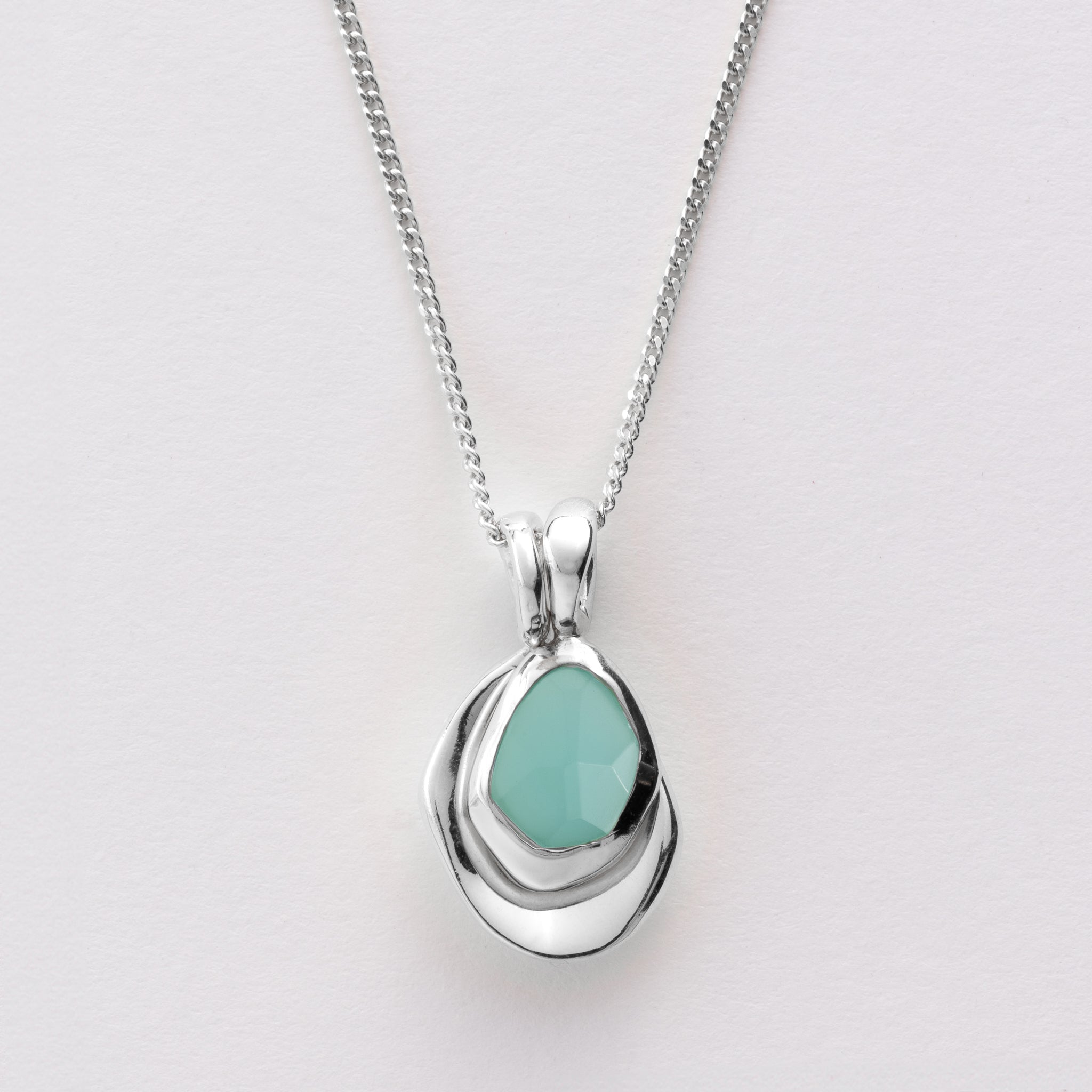 Pebble Charms necklace features a smooth, polished Pebble charm, nestled alongside a sparkling handcut Gemstone charm.
