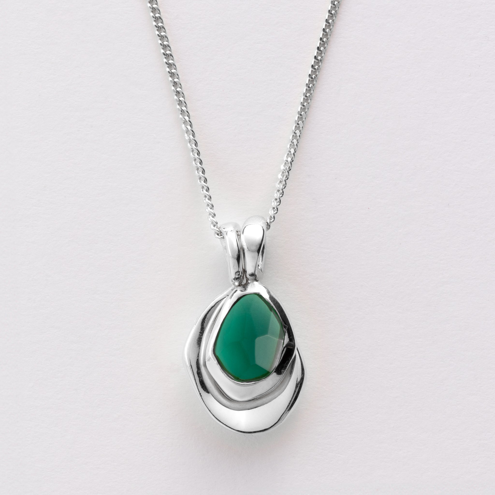 Pebble Charms necklace features a smooth, polished Pebble charm, nestled alongside a sparkling handcut Gemstone charm.