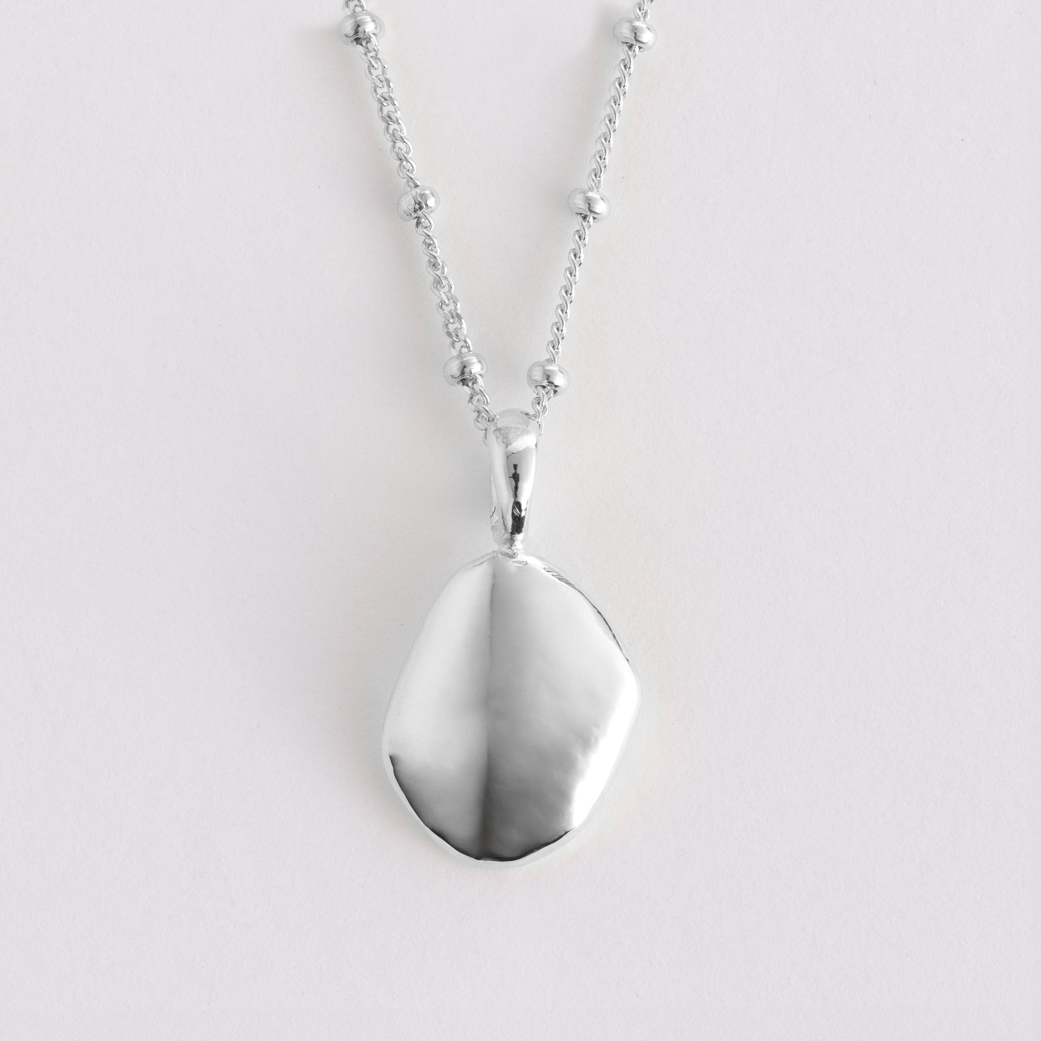 Pendant features a handcut natural pebble shape and is crafted from sterling silver or 18ct gold vermeil.
